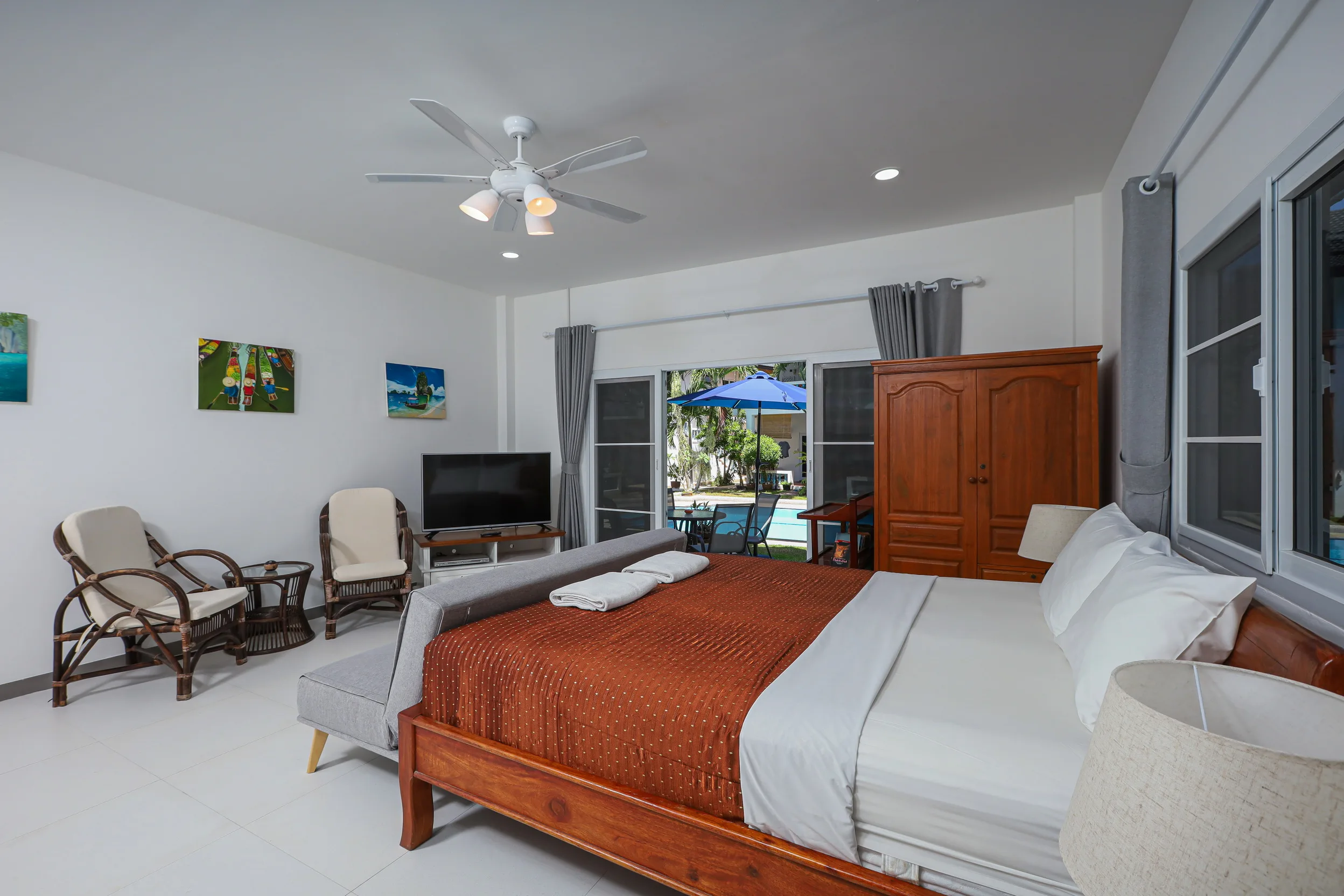 Studio bed view with direct access toward poolside terrace