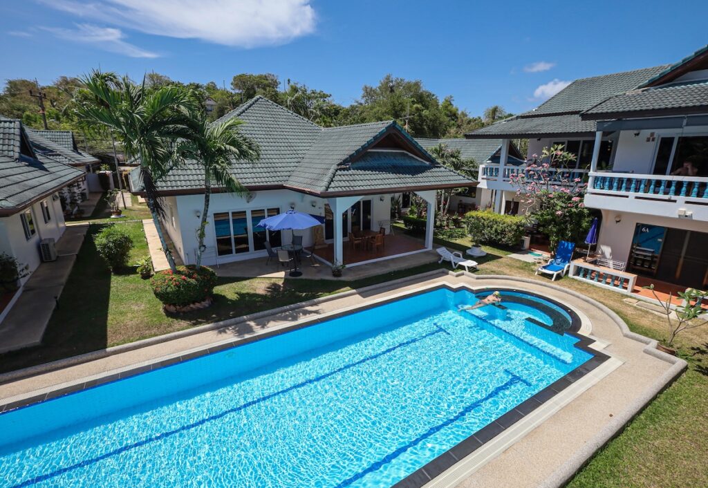 Aerial view of Yanui Breeze resort in Phuket, featuring a swimming pool, private villas, and lush tropical gardens.