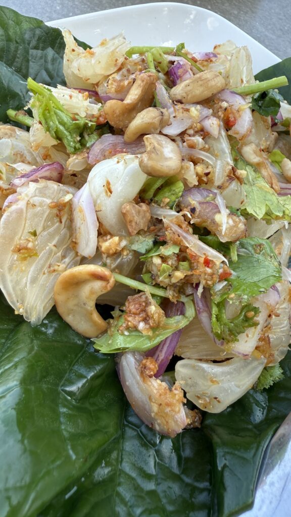 Fresh and tangy Thai papaya salad (Som Tam) with peanuts and chili.