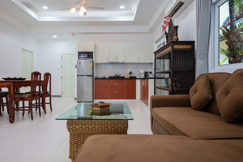 Modern living room and fully equipped kitchen in Yanui Breeze apartment, Phuket.